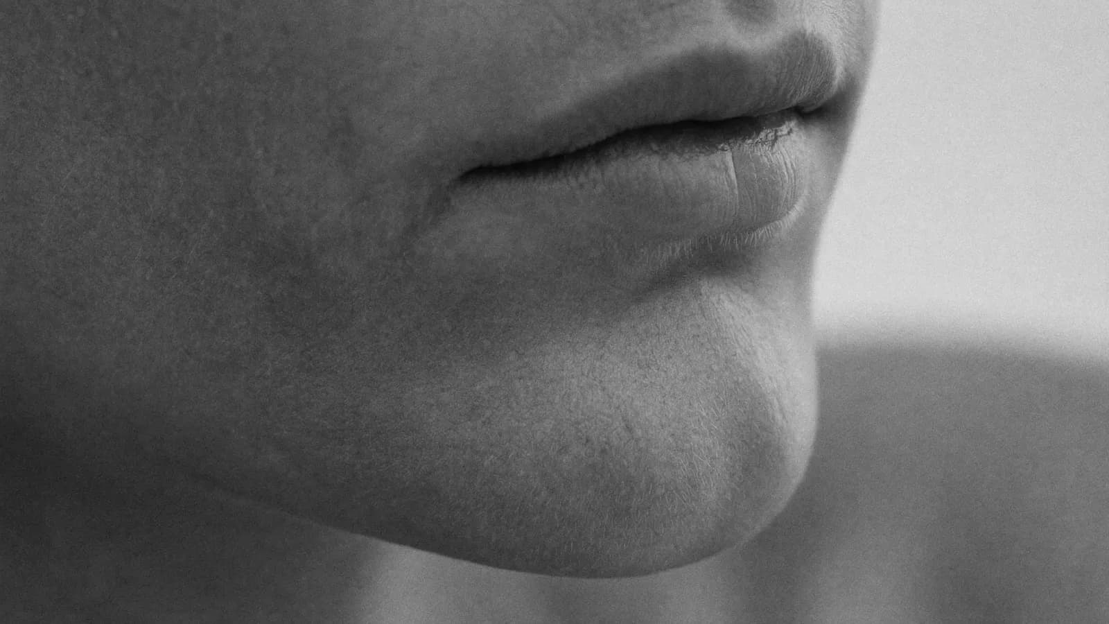 Natural, softly defined lips in profile, lit from the side